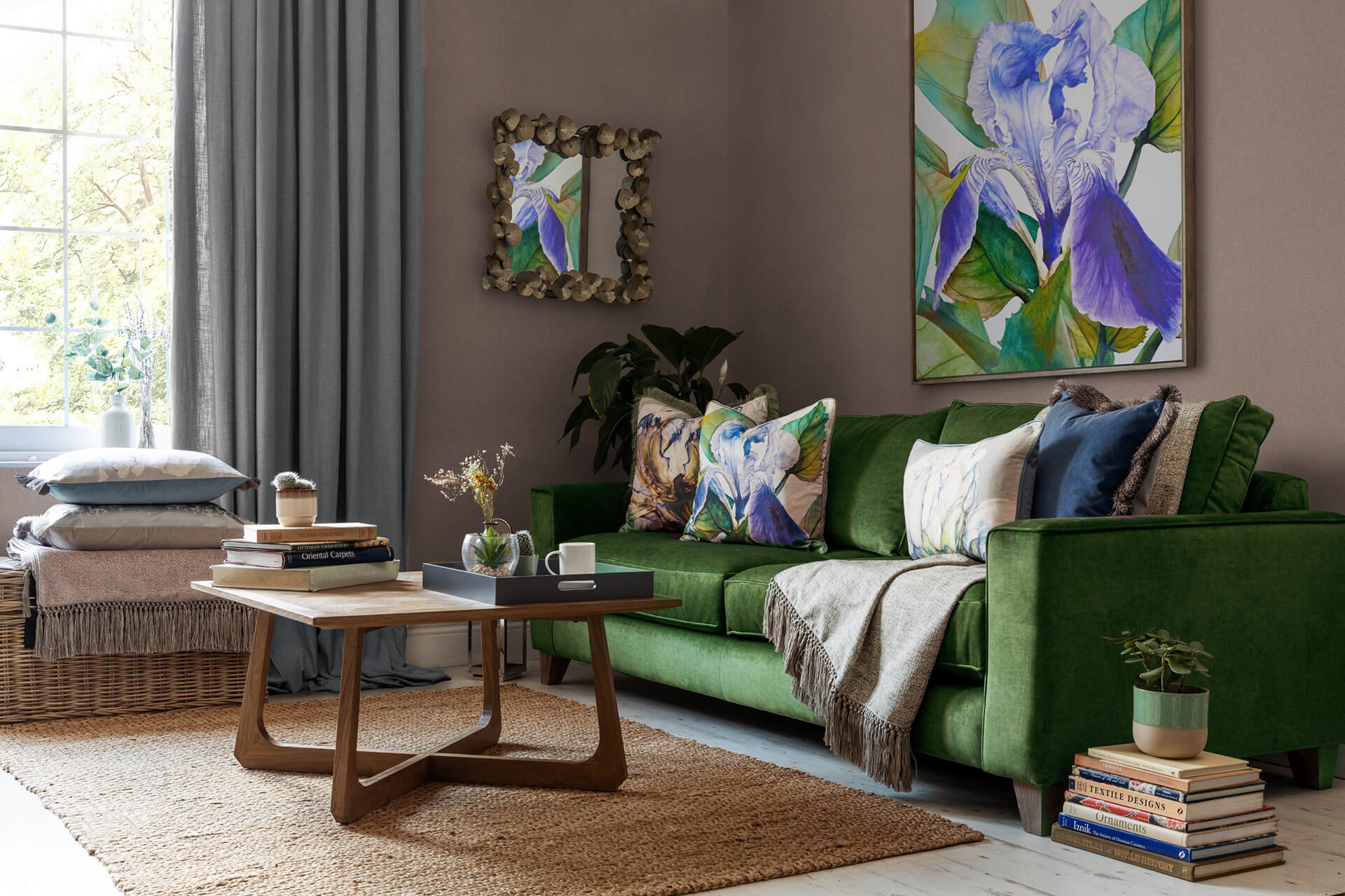 Bespoke sofa, cushions and upholstery in a nicely furnished living room with green, purple and floral fabrics.