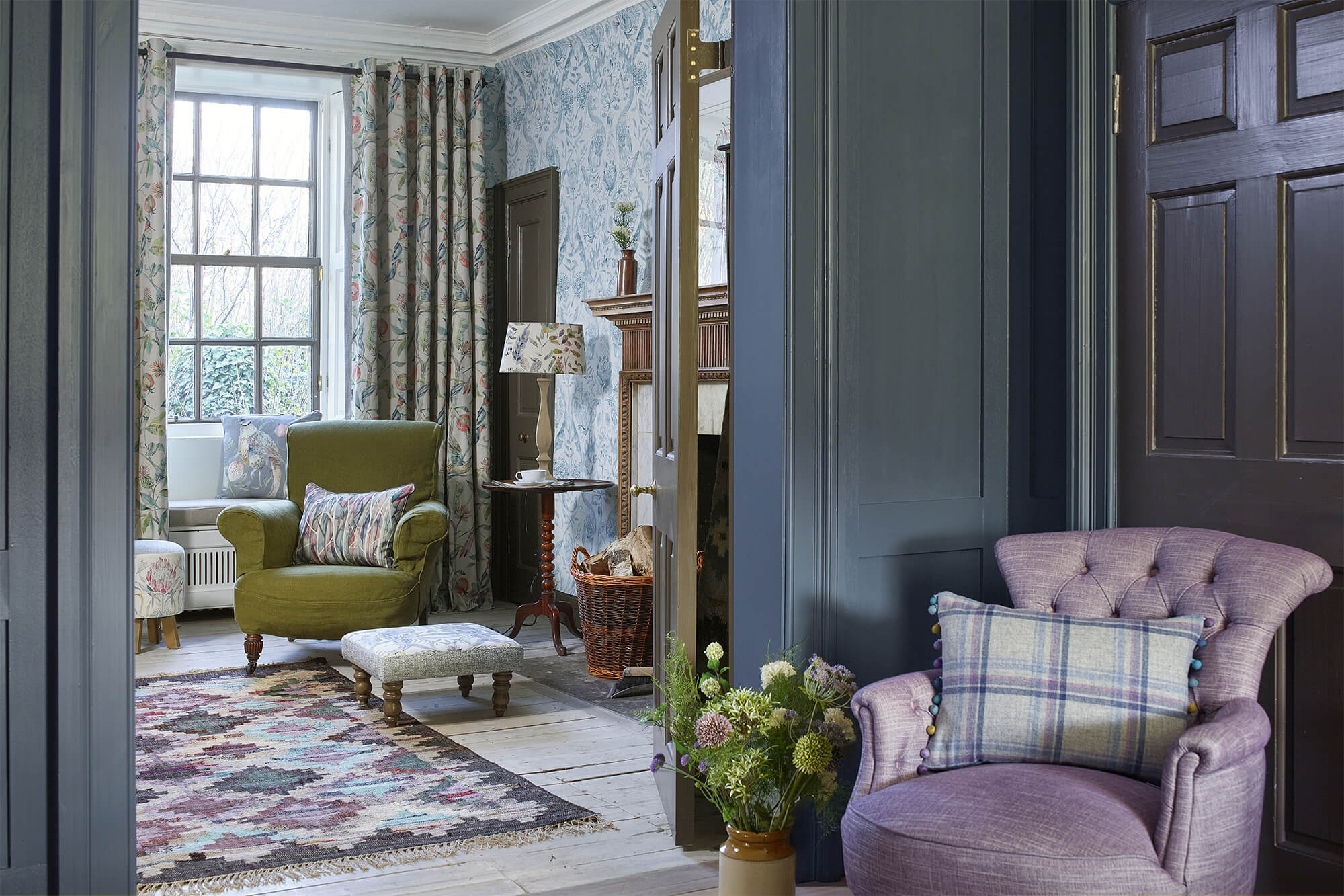 Bespoke reading chairs, cushions and upholstery in a countryside styled living room with purple, blue and green fabrics.